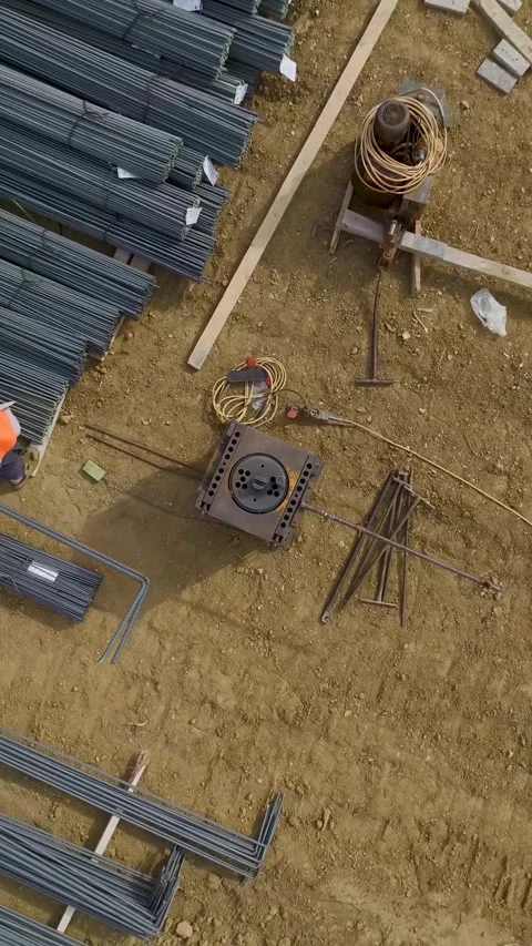 Vertical Video: Construction begins as workers pour the first layer of concrete Stock Footage 297666665