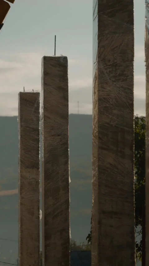 Vertical video Construction of concrete columns and roof installation at a new Stock Footage 327601394