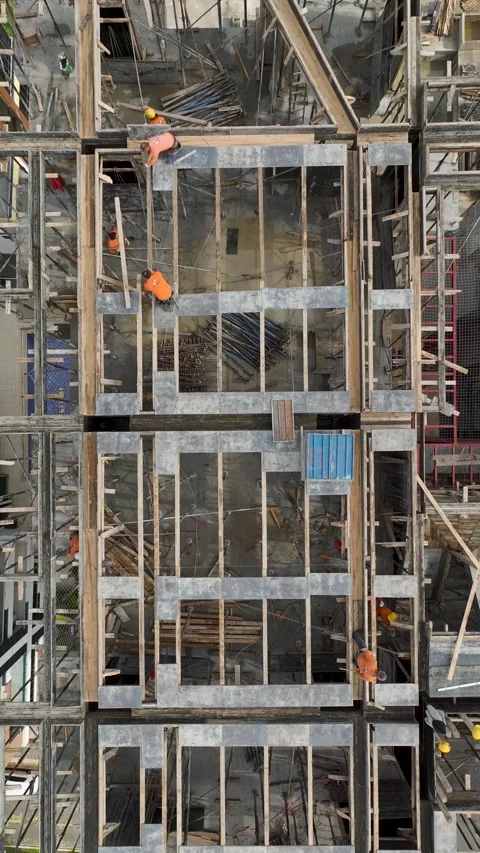 Vertical Video Construction Process with Workers Installing Wooden Supports on Stock Footage 342435141