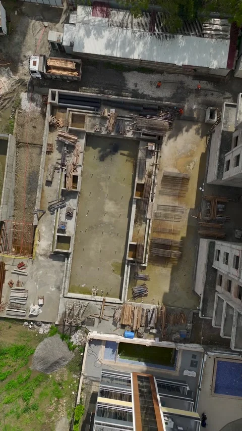Vertical Video Construction Site Activity with Workers Installing Floor Video stock 342435923