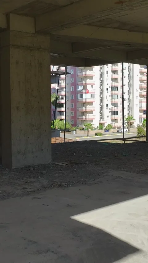 Vertical Video: The construction site buzzes with activity as workers install a Stock Footage 297628462