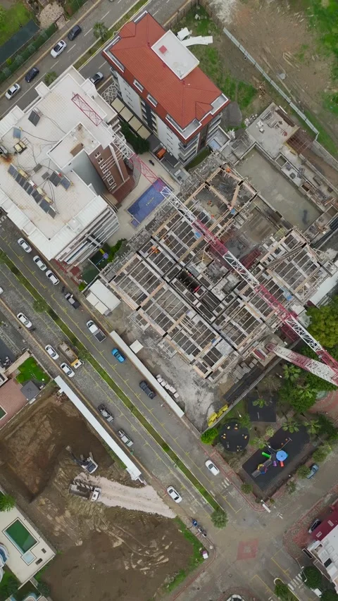Vertical Video Construction Site with Workers Preparing Materials and Installing Stock Footage 342432503
