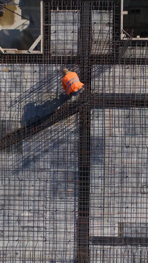 Vertical Video: Construction Site With Workers Completing Floor Preparations and Stock Footage 342564120