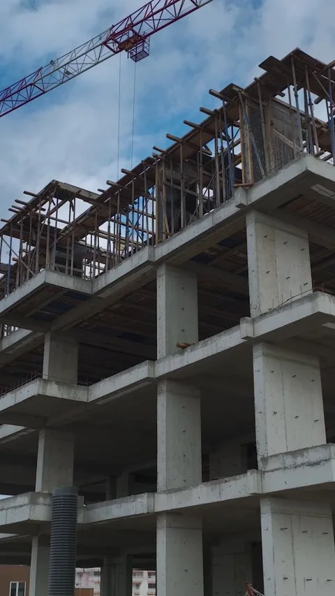 Vertical Video of Construction Team Setting Wall Blocks on High Floors Stock Footage 342409624
