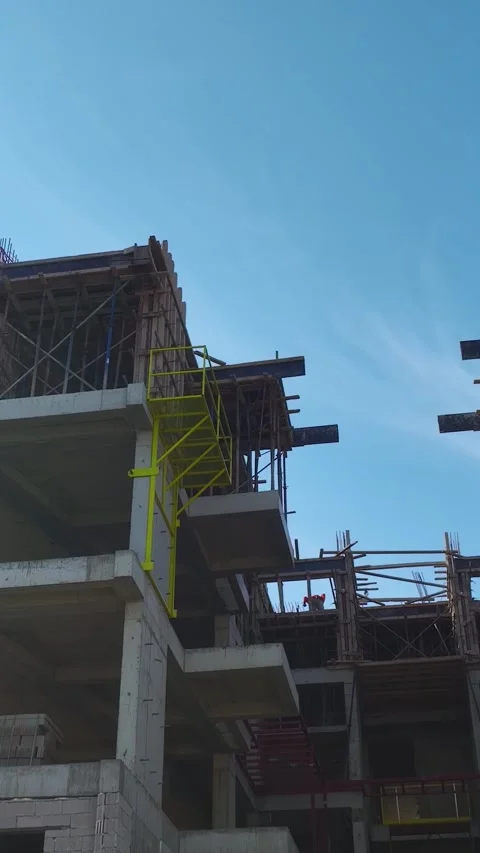 Vertical Video: Construction Teams Building Walls and Using Concrete Mixers on a Stock Footage 342603160