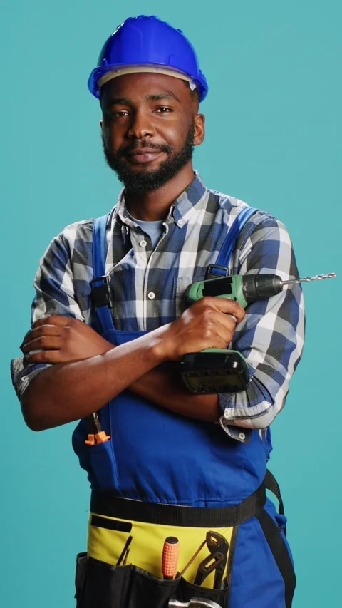 Vertical video: Construction worker posing with power drill gun Stock Footage 233667238