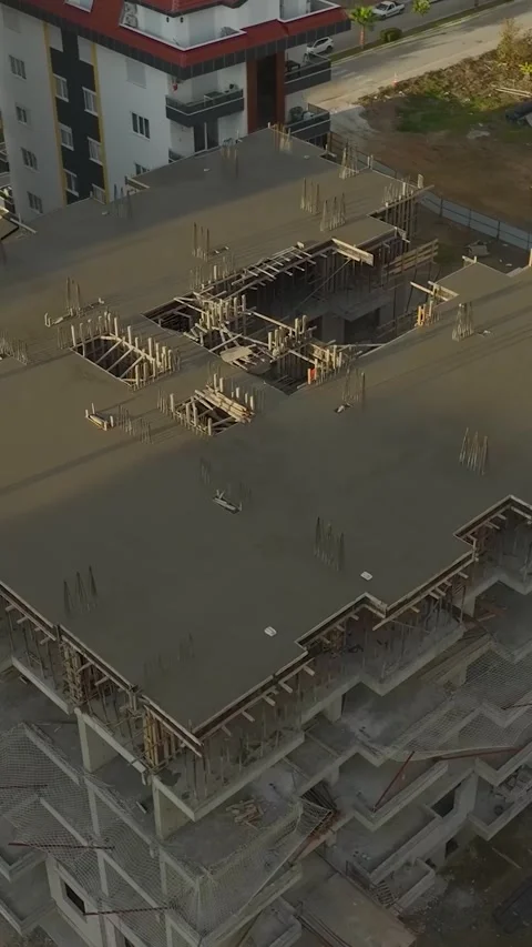 Vertical Video: Construction workers actively pouring concrete for the Stock Footage 297656242