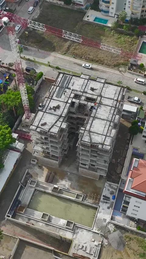 Vertical Video: Construction workers handle stone slabs and metal beams to Stock Footage 297639664