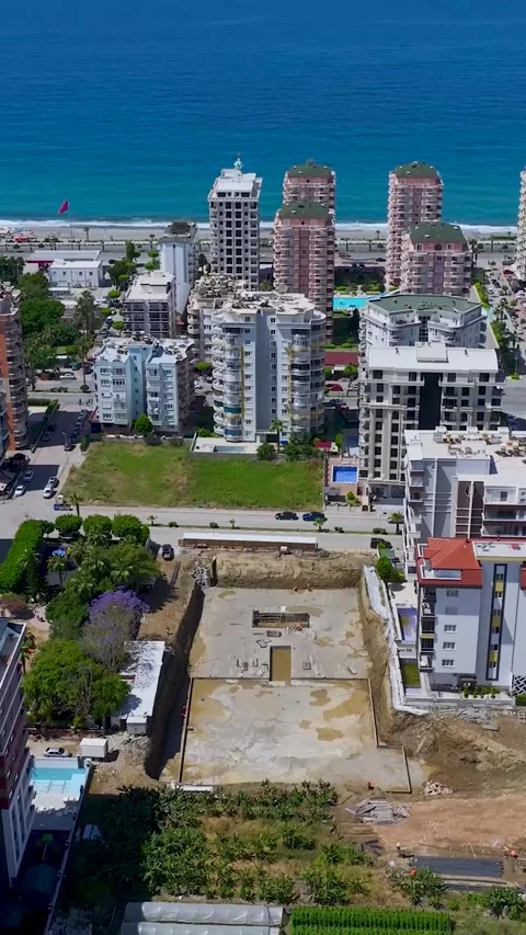 Vertical Video: Construction workers pour concrete into the foundation of a new Stock-Footage 297672193