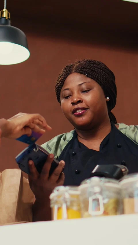 Vertical Video Consumer making card payment at organic shop checkout Stock Footage 262054663