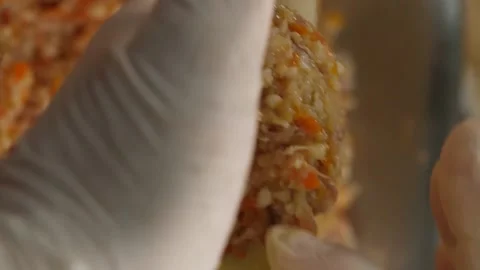 Vertical video. The cook holds the stuffed cabbage and pours a spoonful of meat Video stock 220131979