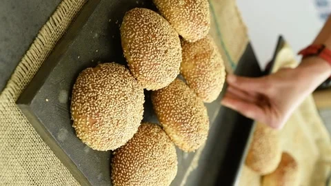 Vertical video. The cook serves a cheese filled bread rolls on the table. Stock Footage 311046061