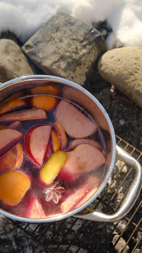Vertical video of cooking mulled wine on campfire in camping conditions Stock Footage 300942472