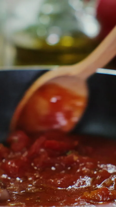 Vertical video. Cooking Tomato Sauce with Fresh Vegetables. Stock Footage 345060250