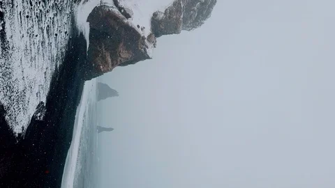 Vertical video, copter Flying Over The Black Volcanic Beach In Iceland Stock Footage 128515824