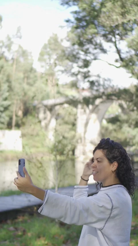 Vertical video with copy space of a young brunette girl with curls happily Stock Footage 254599985