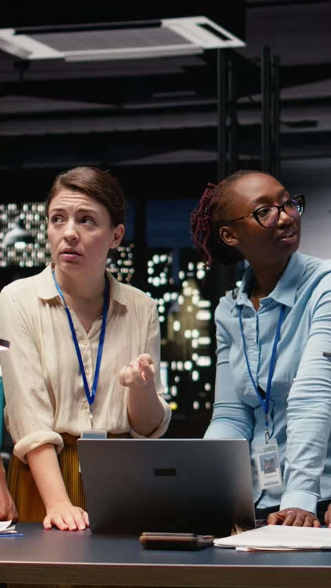 Vertical Video Corporate team gathered around office desk collaborating on Stock Footage 334103541