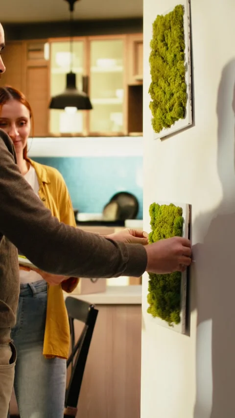 Vertical Video Couple arranging decorations and paintings on the wall in new Stock Footage 343350101