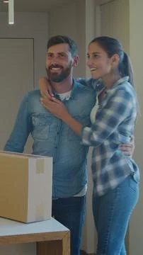 Vertical Video Couple Carrying Boxes Into New Home On Moving Day. Fotos Stock