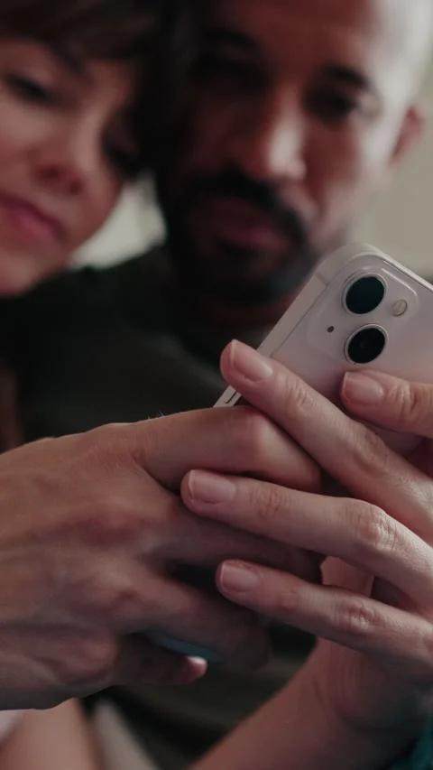 Vertical video, Couple At Home Browsing Smartphone Together Stock Footage 301457108