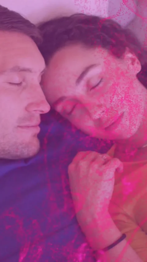 Vertical video: Couple lying on bed, third frame starting pink haze over faces, Stock Footage 330919674