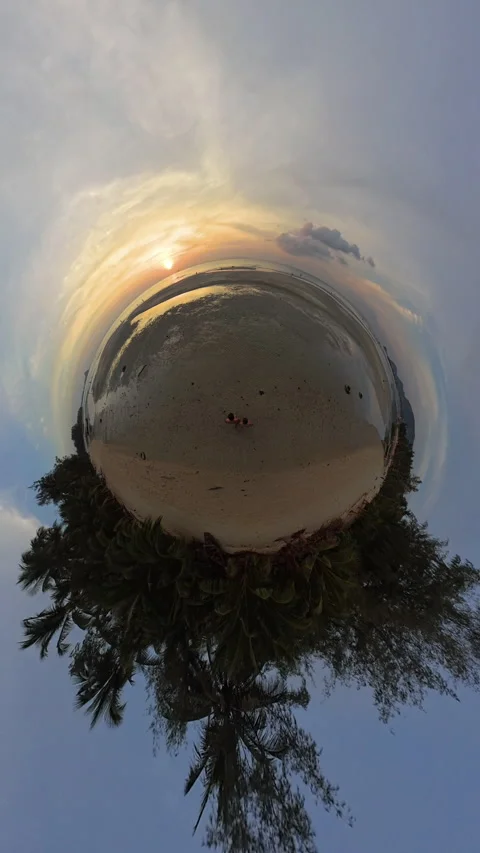 Vertical video. A Couple Sits on a Sandy Tropical Shore in a Little Planet View Stock Footage 327416990