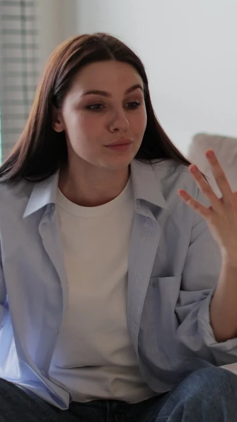 Vertical video Couple sitting on sofa in living room arguing over disagreement Stock-Footage 337650129