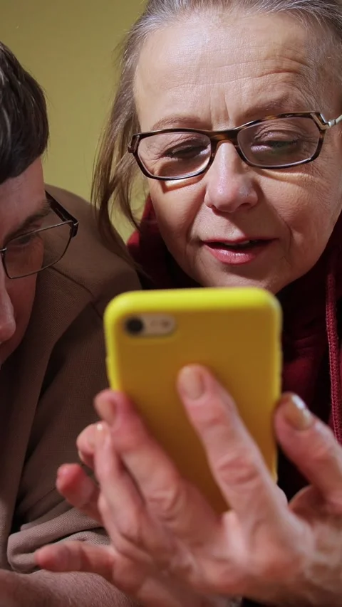 Vertical video. Couple using smartphones while lying on bed at home in the Stock-Footage 309812097