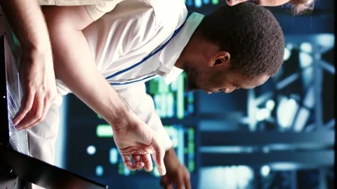 Vertical video Coworkers running data center tests Stock Footage 246391997