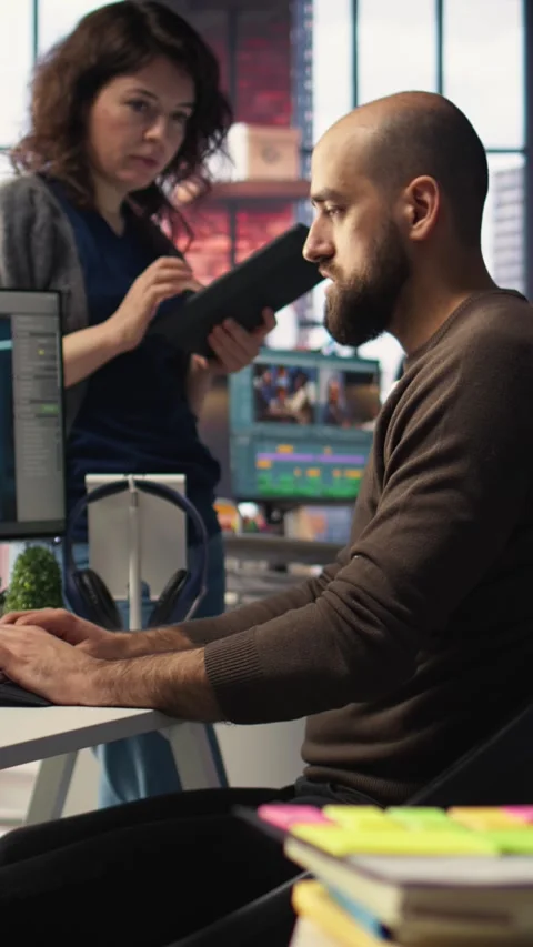 Vertical Video Coworkers using AI chatbot interface to generate video game Video stock 308493079