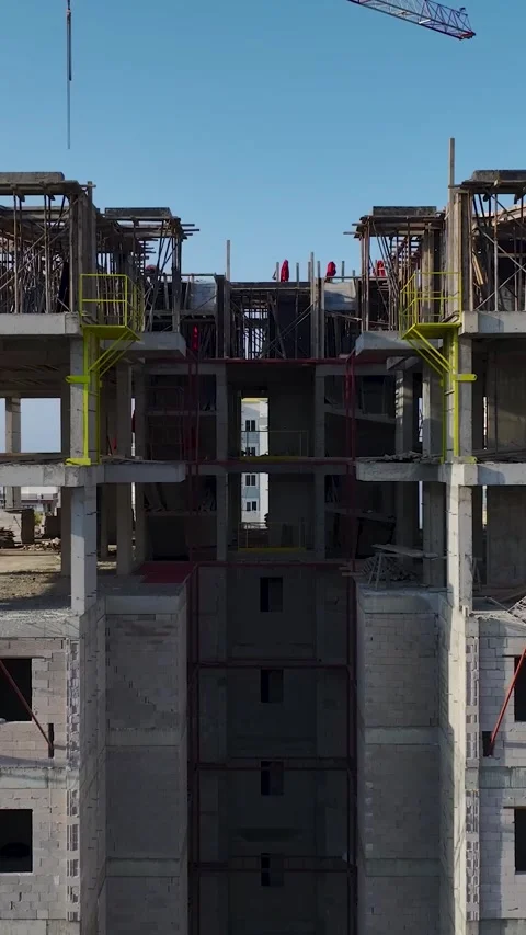Vertical Video Crane Lifting Materials Over Coastal Construction Site Stock Footage 342121557