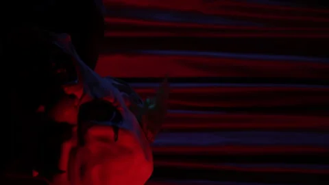 Vertical video of crazy man with pig mask shaking head back and forthin font of Stock Footage 233579112