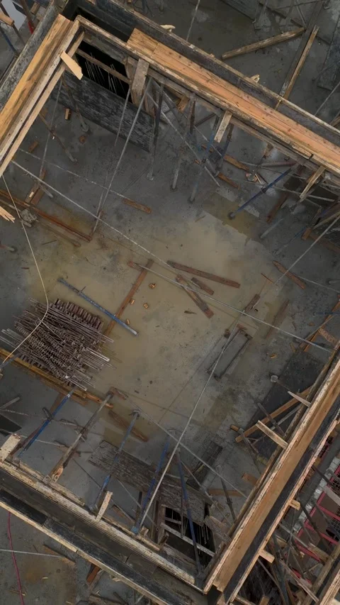 Vertical Video of Crew Aligning Wall Components During High-Level Construction Stock-Footage 342408212