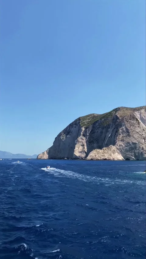 Vertical video Crystal Clear Blue Waters and Rugged Greek Stock Footage 308808401