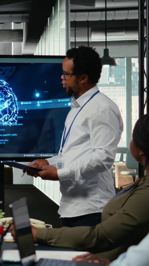 Vertical video CTO in startup office doing presentation on deep learning tech to Stock Footage 322696408