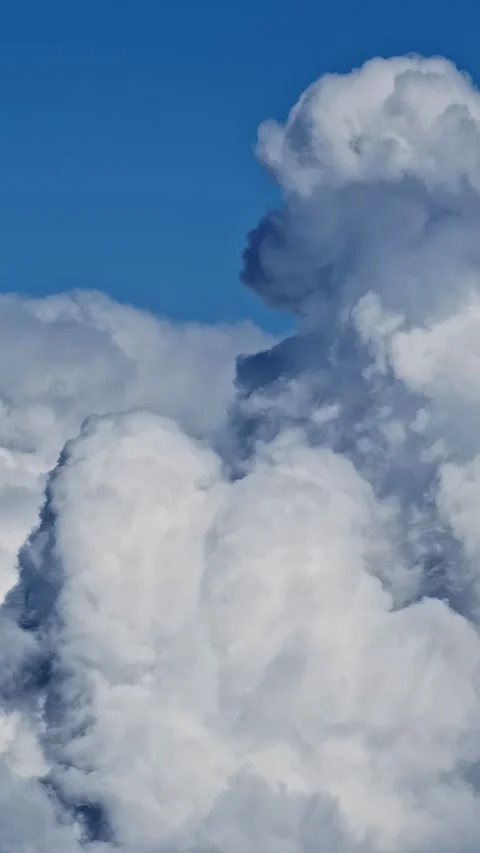 Vertical Video - Cumulus Clouds Moving Against Blue Sky, Close Up Stock Footage 337423807