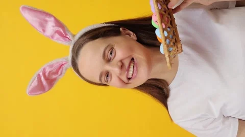 Vertical video. Cute beautiful Caucasian woman wearing rabbit ears headband Stockbeeldmateriaal 293243053