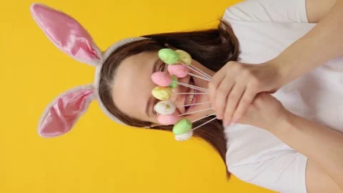 Vertical video. Cute charming Caucasian woman with happy smile wearing rabbit 動画素材 293243097