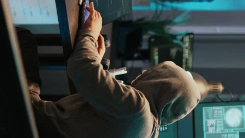 Vertical video: Cyber impostor with anonymous mask breaking security system Stock Footage 221655214