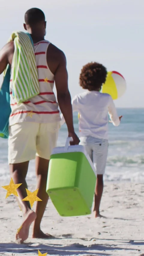 Vertical video: Dad and son walking to sea for play, child tossing ball causing Stock Footage 331237849