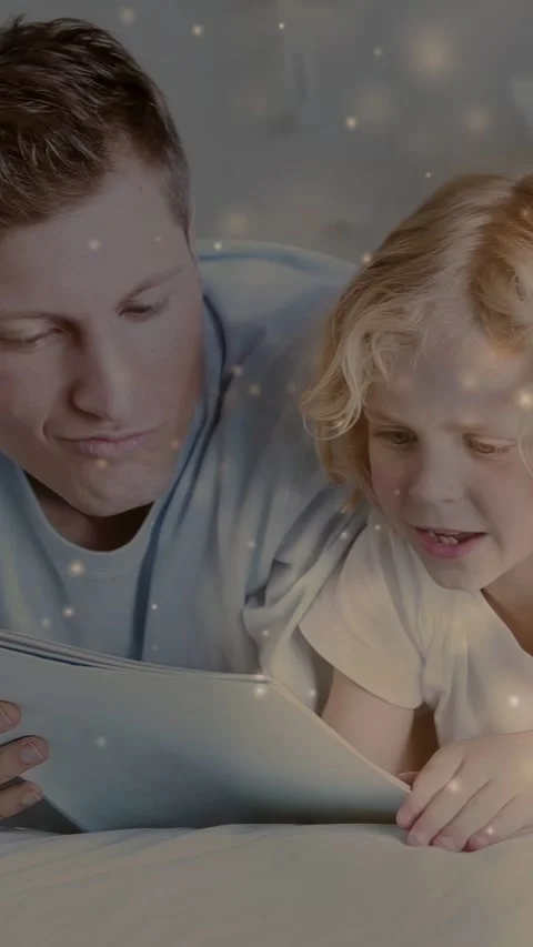 Vertical video: Dad and son on bed child touching tablet engaging learning bokeh Stock Footage 333954145