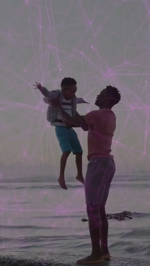 Vertical video: Dad lifting son at shore, cycling lifts for fun, purple overlay Stock Footage 331338216