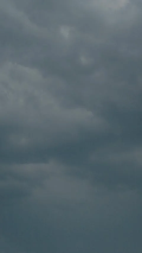 Vertical video Dark clouds gather while rain and lightning create a dramatic Stock Footage 323353022