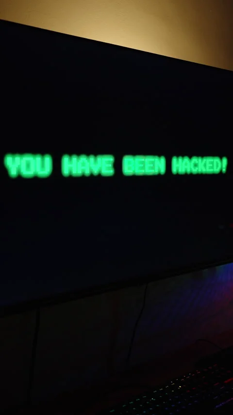 Vertical video. Dark Room with Computer Setup, Monitor Displaying Blinking Green Stock Footage 281460584