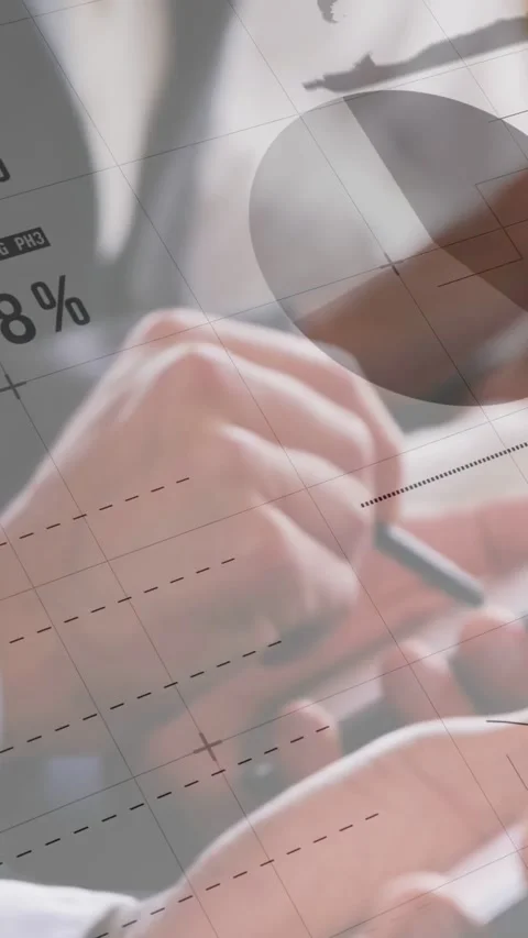 Vertical video: Data analysts tapping tablet and phone, charts updating on Stock Footage 334770680