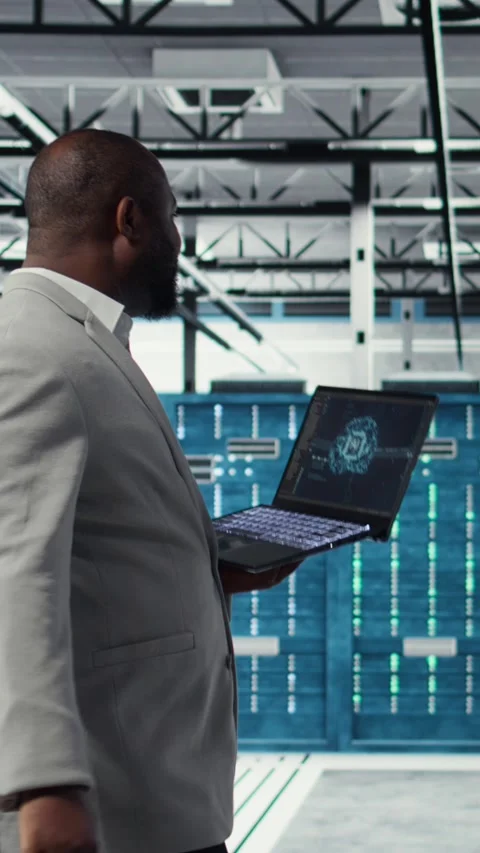 Vertical video Data center admin doing IT maintenance tasks using AI technology Stock Footage 311340449