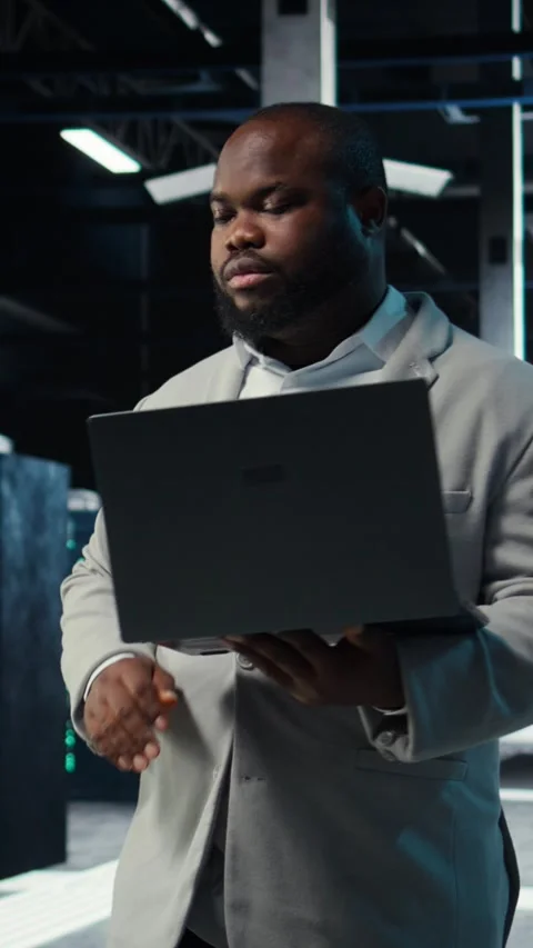 Vertical video Data center admin coding, writing script on laptop, identifying Stock Footage 311341748