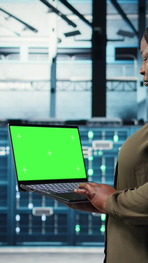Vertical video Data center admin uses isolated screen laptop to develop disaster Stock Footage 317054413