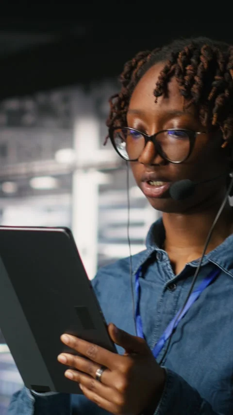 Vertical video Data center engineer wearing headset microphone providing remote Stock Footage 310775053