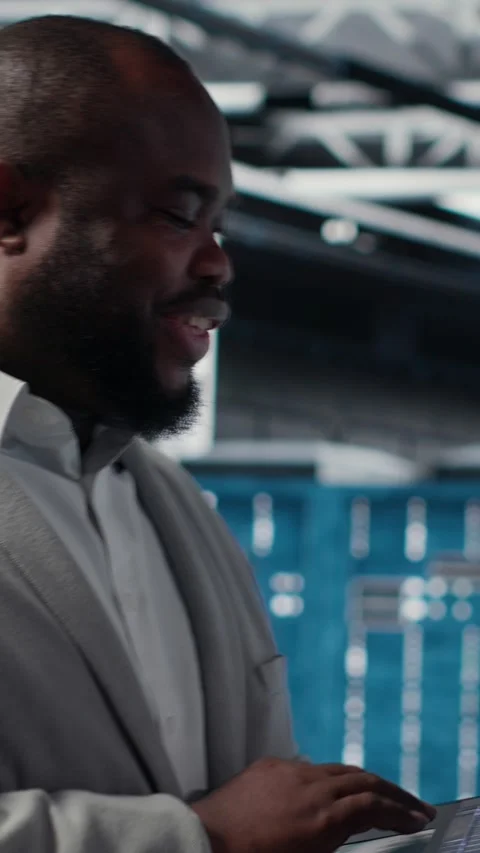 Vertical video Data center engineer deploying AI driven management tools using Stock Footage 311489133